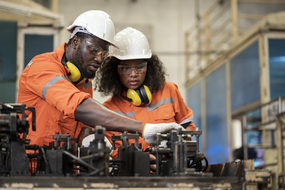 domestic metal fabrication workshop with team working efficiently on production
